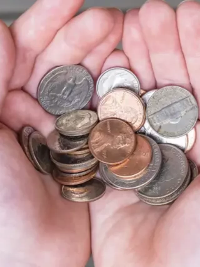 hand-holding-change-coins-penny-quarter-nickel-dime_iStock-837099894